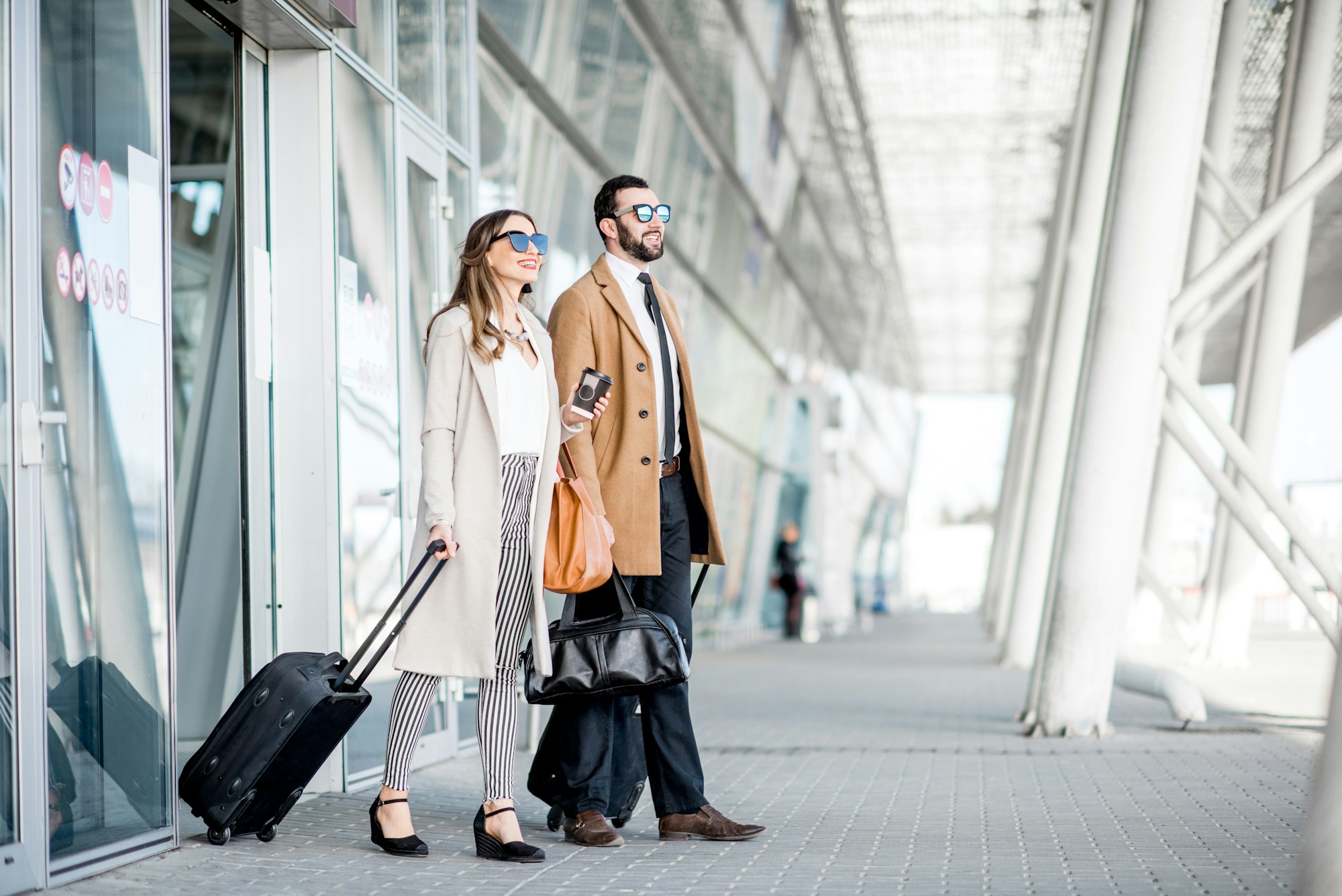 Business couple leaving the airport